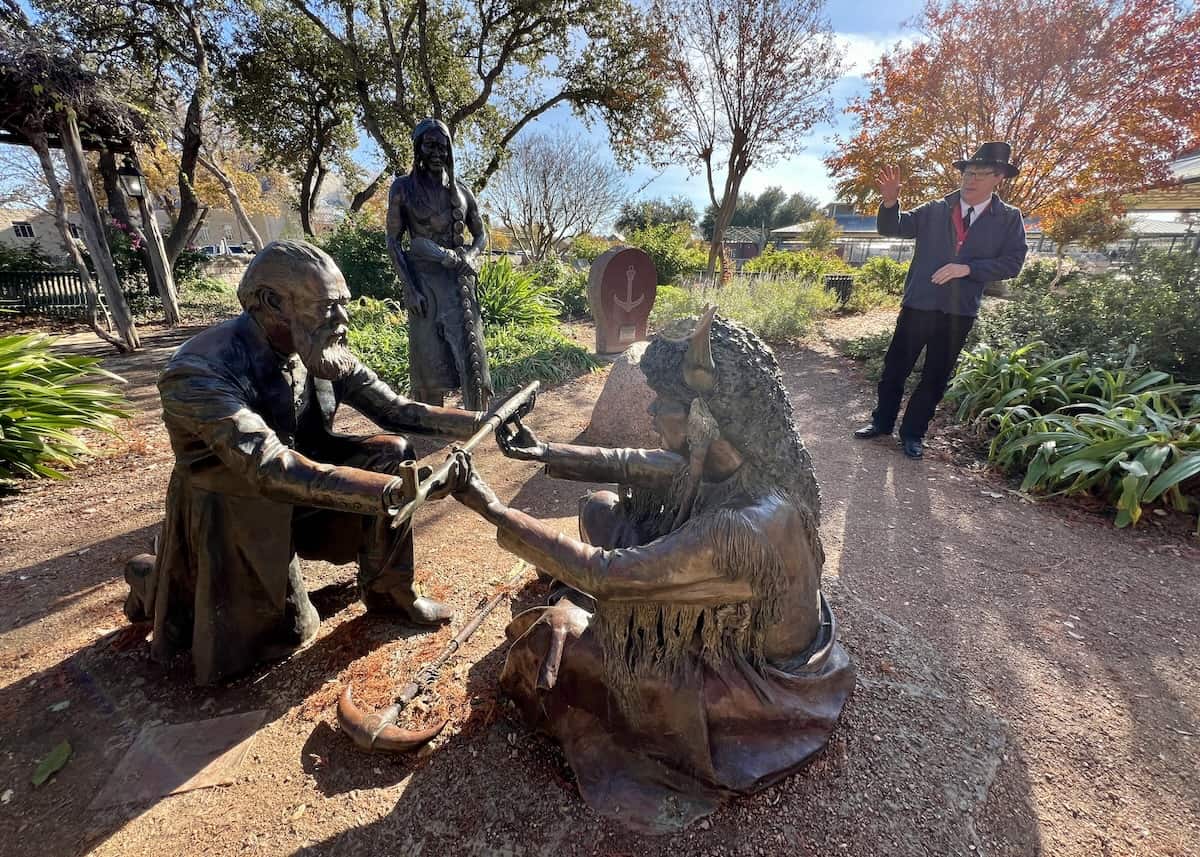 Lasting Friendship monument shows German settler and Comanche Chief with Fredericksburg Trolley driver and historian David D. Schafer